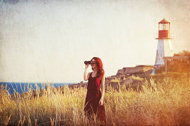girl with binocular near Lighthouse