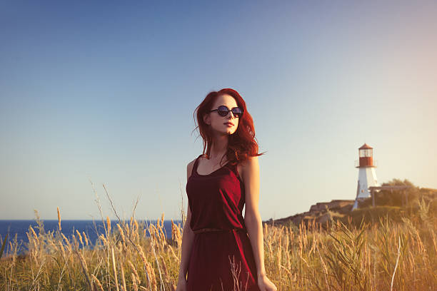 istock girl with sunglasses near Lighthouse 483014294