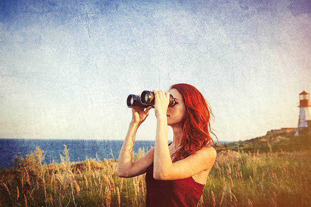 istock girl with binocular near Lighthouse 483014298