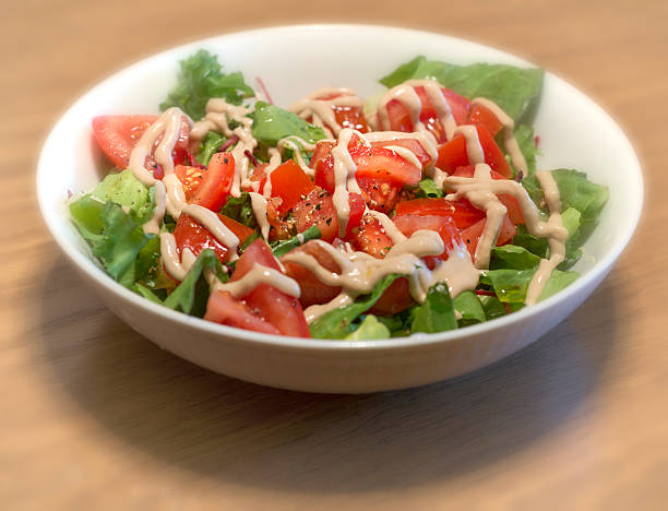 tomato salad- green, yellow and red tomato with lettuce and sauce