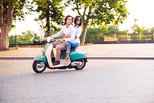 istock trendy couple riding a scooter 483017694
