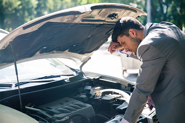 istock Man looking under the hood of car 483018098