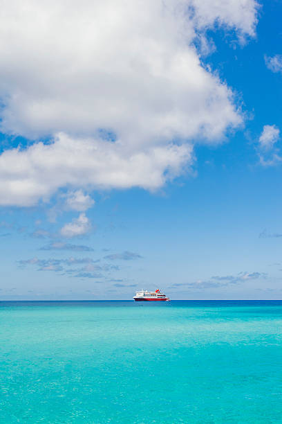 istock Red and white ship sailing through the ocean. 483018394