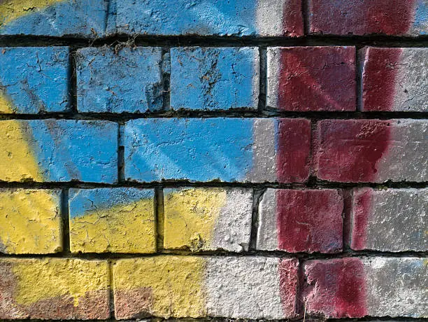 detail of a brick wall decorated with spray paint