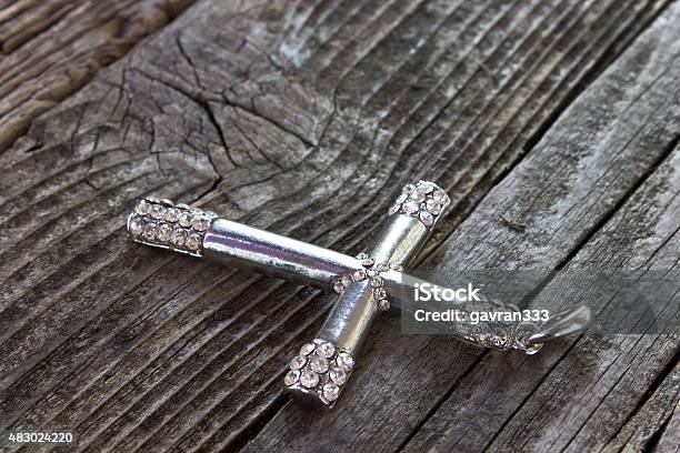 Silver Christian Cross On Wooden Background Stock Photo - Download Image Now - 2015, Catholicism, Christianity