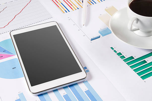 istock Tablet Computer and Business Charts on Office Desk 483027132