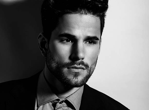 istock handsome young man in suit on grey background 483030472