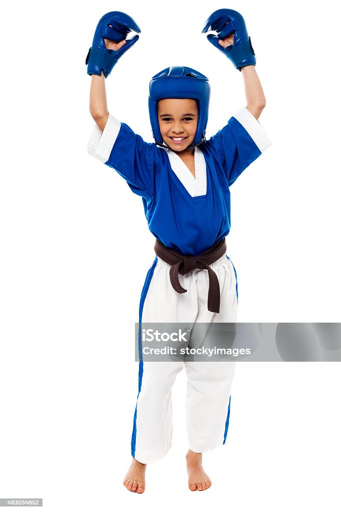 Successfully completed my training. Little girl showing her success in raised arms Martial Arts Stock Photo