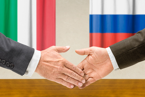 Representatives of Italy and Russia shake hands
