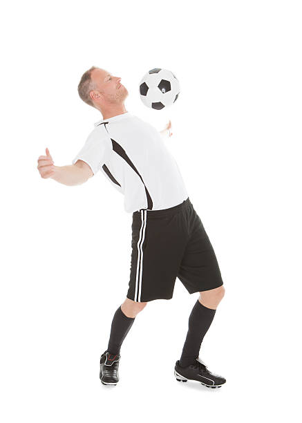 istock Player Hitting Soccer Ball With Chest 483044264