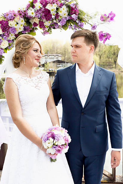 istock bride and groom looking at each other at wedding ceremony 483045112