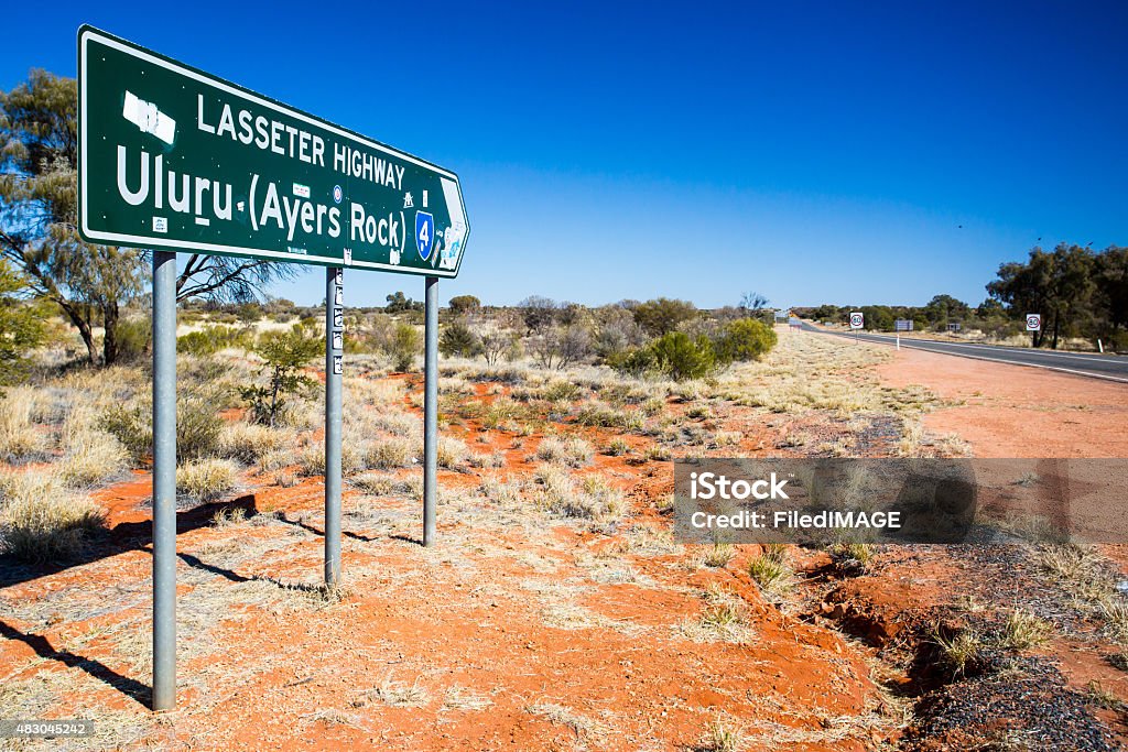 Uluru Road Sign An iconic road sign directing towards Uluru on the Northern Territory, Australia Uluru Stock Photo