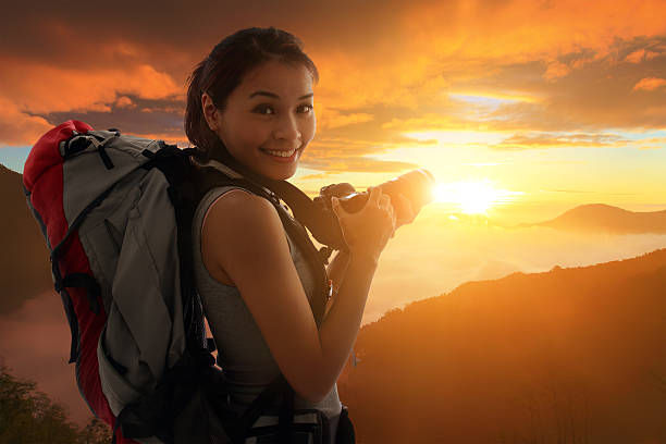 istock Young woman silhouette taking photos 483046715