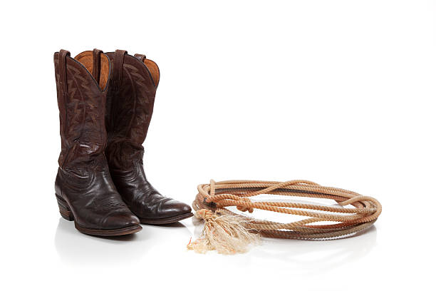 istock Brown leather cowboy boots on white 483047115