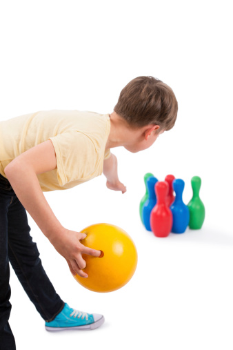 A bowler boy releases the ball (over The Shoulder View). Isolated on white stock image.
