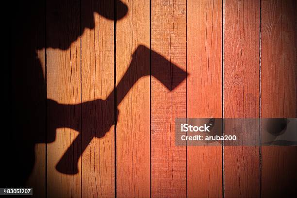 Human Silhouette With Axe In Shadow On Wooden Background Xxxl Stock Photo - Download Image Now