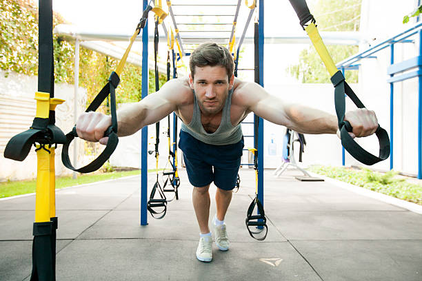istock Man during workout with suspension straps on the street 483056232