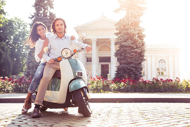 istock Happy young couple on scooter 483060916