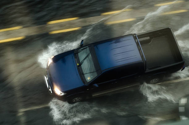 flooded street driving flooded street driving in rainy stromy weather condition truck rain stock pictures, royalty-free photos & images