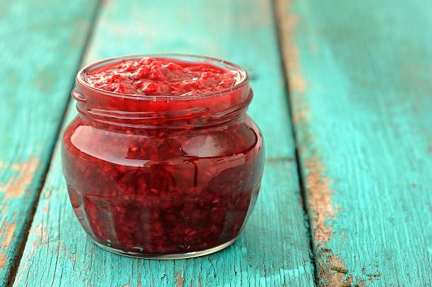 istock Nice glass jar with homemade sweet raspberry jam 483062778