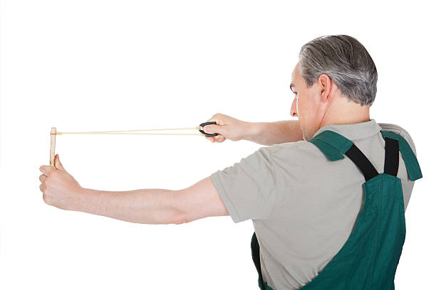 istock Close-up of hand pulling sling shot 483063116