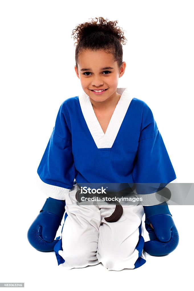 I am the next in practice. Happy karate girl sitting on floor after practice 2015 Stock Photo