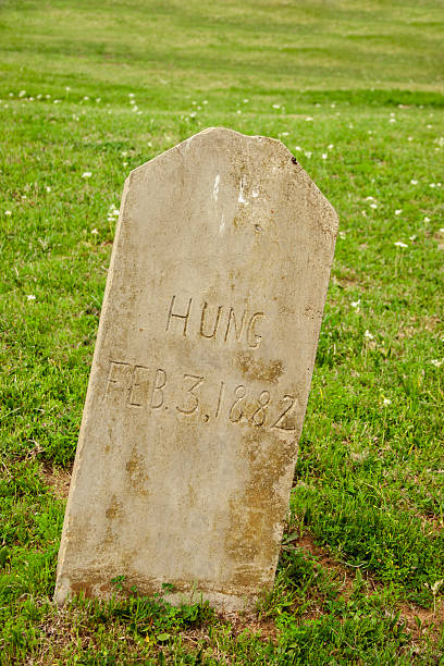 istock Old tombstone in cemetary.  Man was hung, 1882. 483073245