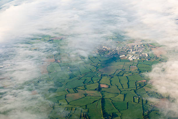 Aerial view of small town and countryside in Ireland. Sheep are visible in some fields at 100%