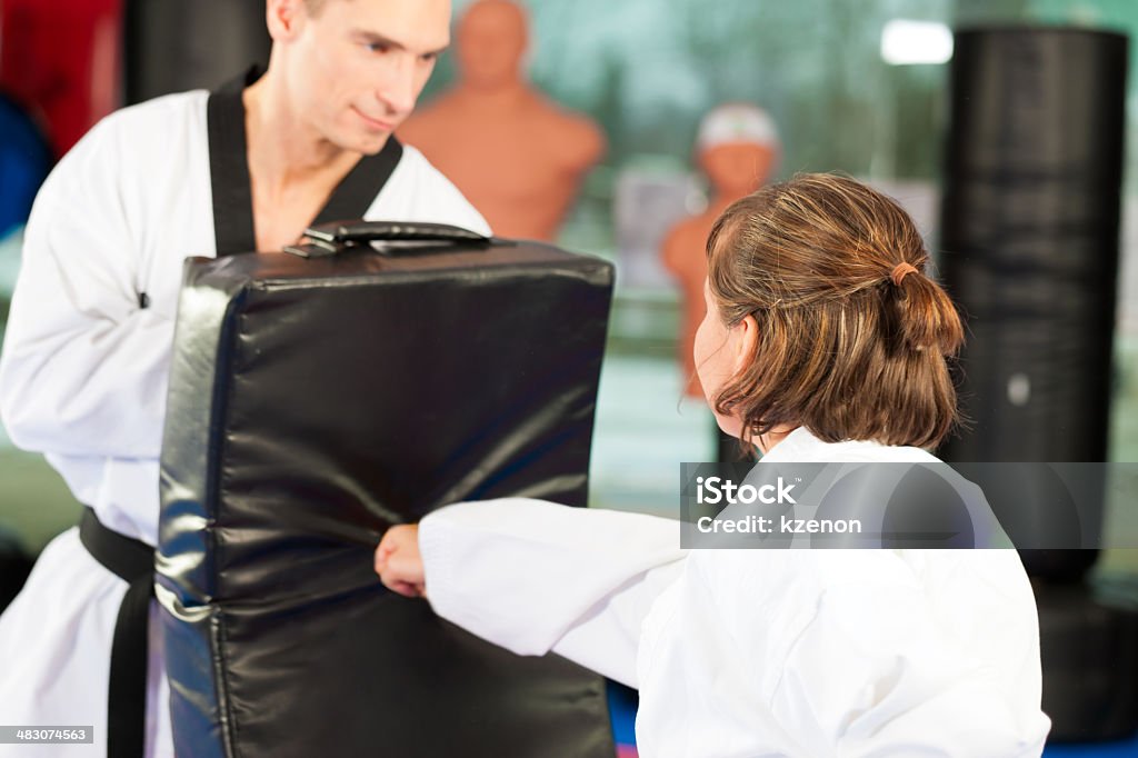 Martial Arts sport training in gym People in a gym in martial arts training exercising Taekwondo, he is the trainier or master Adult Stock Photo