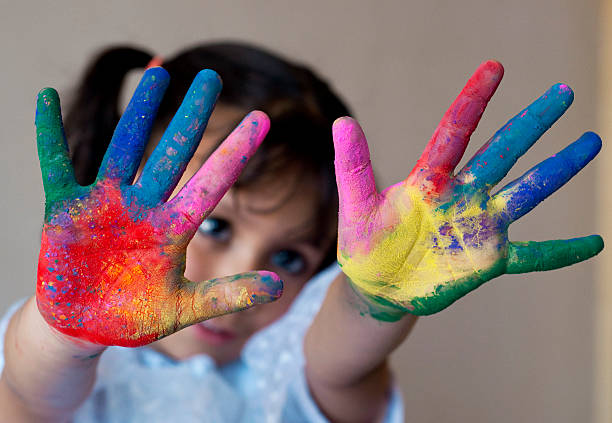 istock Girl showing colorful painted hands 483074771