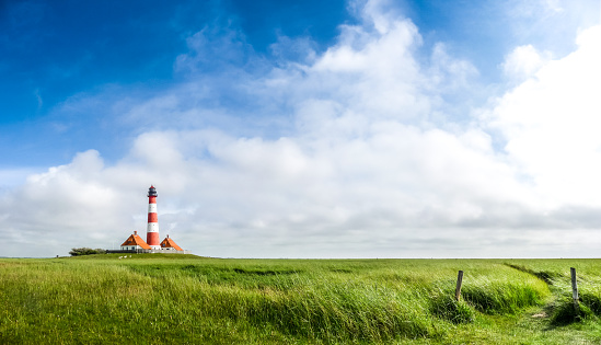 Beautiful landscape with famous Westerheversand lighthouse in the background at North Sea in Nordfriesland, Schleswig-Holstein, Germany.