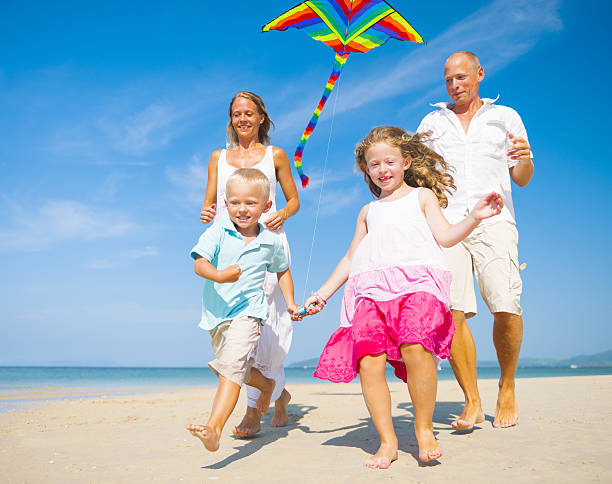 istock Family Flying a Kite on the Beach 483078449