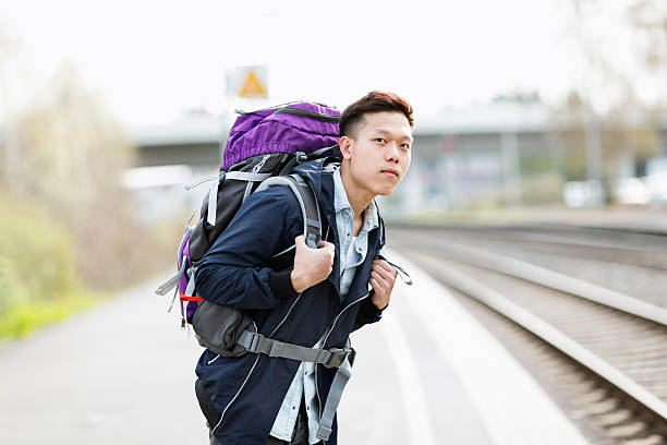 istock young asian backpacker man traveling with train 483079783