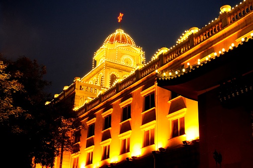 Government building at night decorated with lights to commemorate National Day in Beijing, China