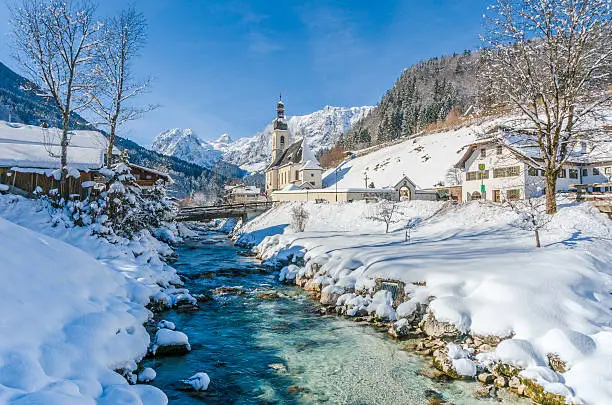 Panoramic view of scenic winter landscape in the Bavarian Alps with famous Parish Church of St. Sebastian in the village of Ramsau, Nationalpark Berchtesgadener Land, Upper Bavaria, Germany.