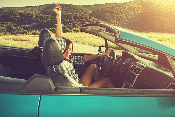 istock Attractive young woman in a convertible 483083216