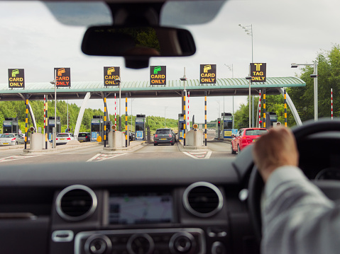 West Midlands, UK - June 19, 2015: A view from a car interior, on approach to the southbound M6 Toll road payment barriers. The privately funded motorway was opened in 2003.