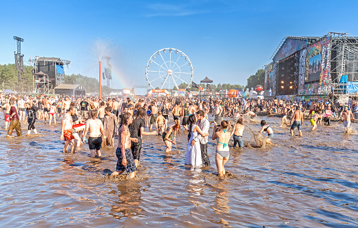 Kostrzyn nad Odra, Poland - August 1, 2015: People playing in mud during 21th Woodstock Festival Poland (Przystanek Woodstock), one of the biggest open air festival's in Europe.