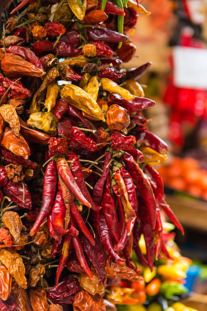 istock chillies or red pepper hanging at a market 483088310