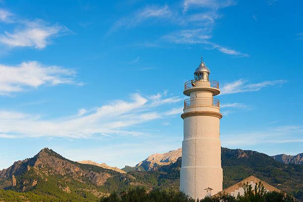 Lighthouse Far del Cap Gros in Mallorca Spain, in the background the mountains of the coast