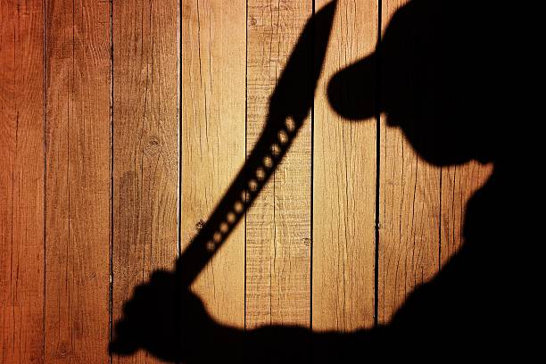 Human Silhouette with Machete in shadow on wooden background, X Human Silhouette with Machete in Shadow on wooden background, with space for text or image. Machete stock pictures, royalty-free photos & images