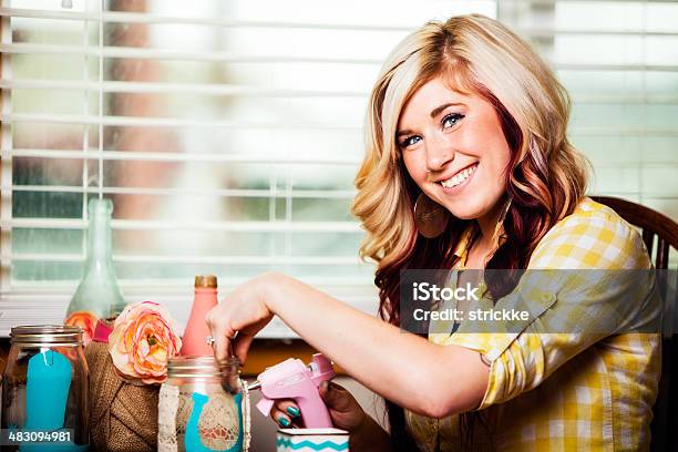 Smiling Young Woman Uses Hotglue Gun For Craft Project Stock Photo - Download Image Now