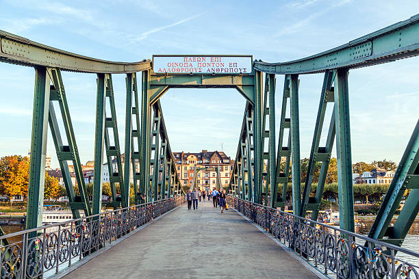 Frankfurt, Germany - September 6, 2012: people at Eiserner steg in Frankfurt, Germany. The Eiserner Steg is a pedestrian bridge in Frankfurt am Main built in 1868.
