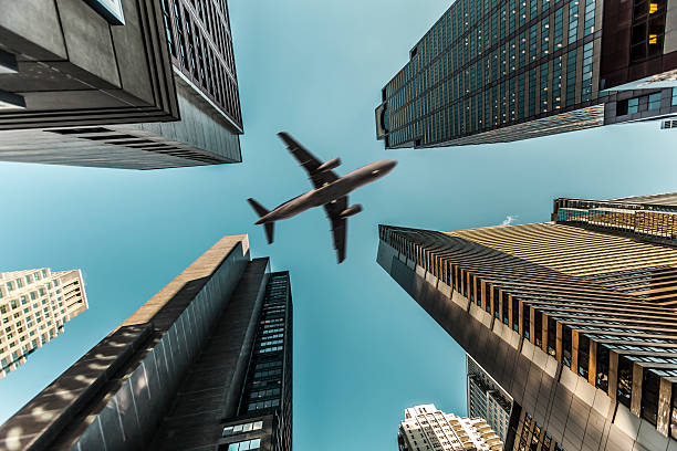 istock Airplane Over Business Towers 483095835