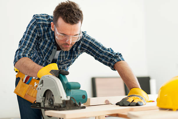 Focus carpenter sawing wood board