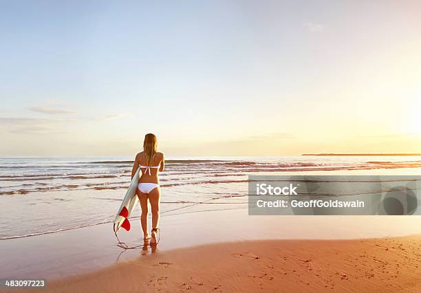 Young Surfer Walking Out To Enjoy The Surf At Sunrise Stock Photo - Download Image Now