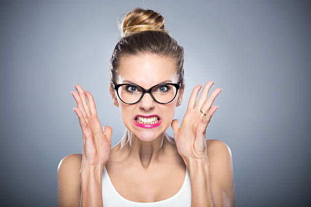 Angry young woman Angry young woman clenching teeth stock pictures, royalty-free photos & images