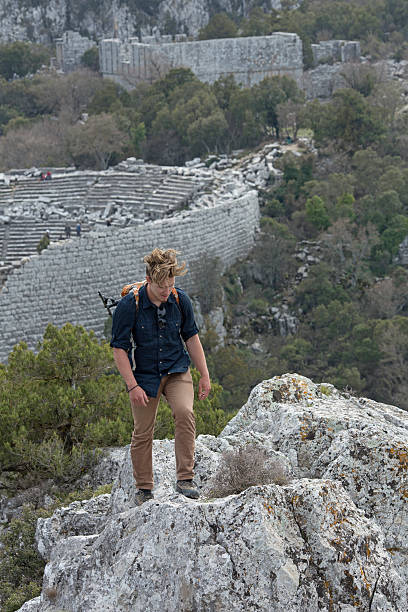istock Young man hiking above theatre, ancient Greek ruin 483098210