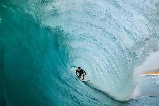 A professional surfer finds himself perfectly pitted deep within a North Shore barrel