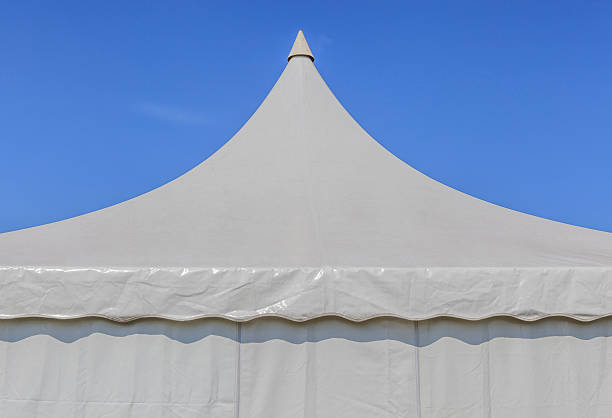 istock Looking upthe top of white tent with sky background. 483101108